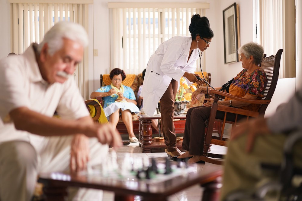 elderly care home with nurse attending a person