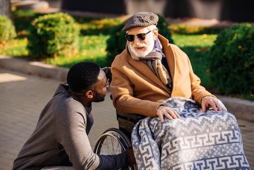 man helping elderly man